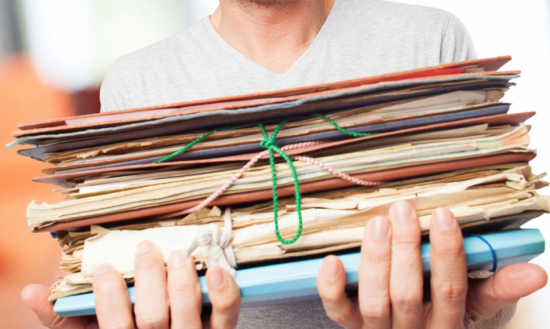 Teacher holding a pile of documents